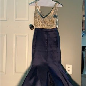 A poofy prom dress,that is blue and gold.